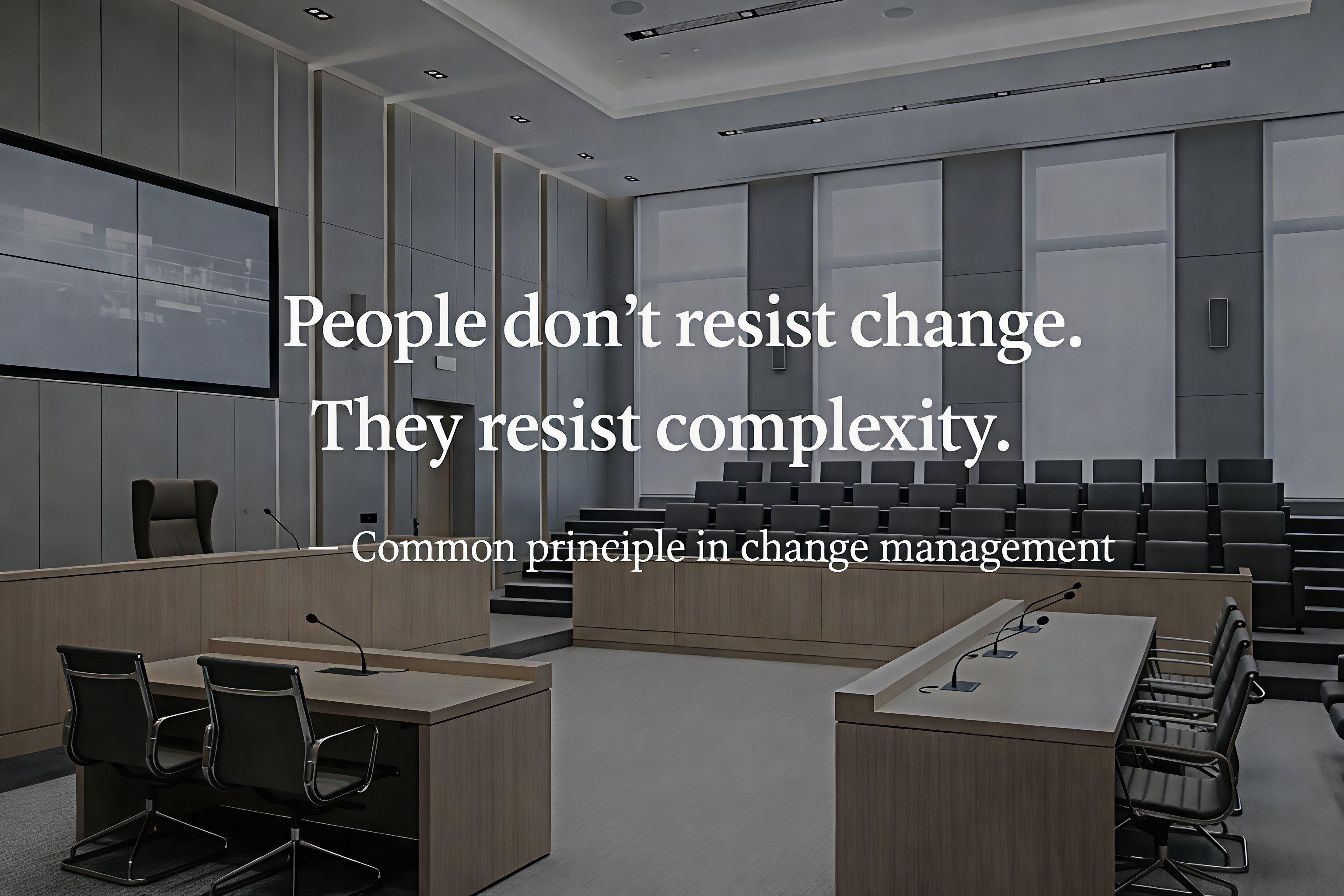 Empty modern courtroom with seating and desks visible, overlaid with the quote, &ldquo;People don&rsquo;t resist change. They resist complexity,&rdquo; attributed to a common principle in change management.